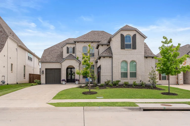 Two-story home exterior with a wide driveway