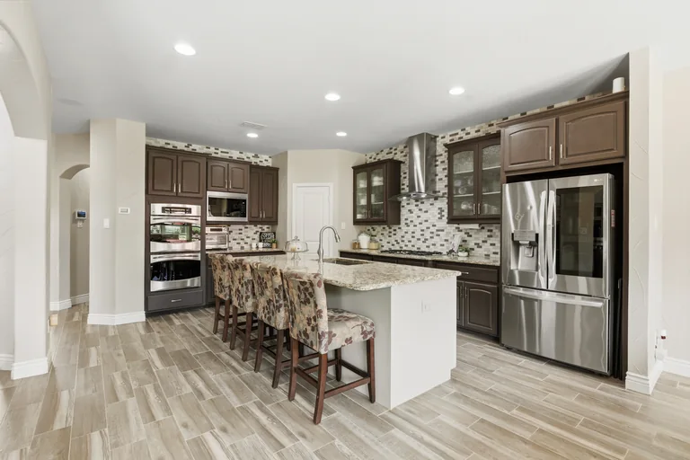 Kitchen island, cabinetry and appliances at 1000 Monticello Drive in Prosper