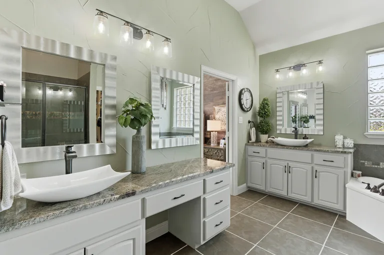 Bathroom vanity and soaking tub at 1000 Monticello Drive in Prosper