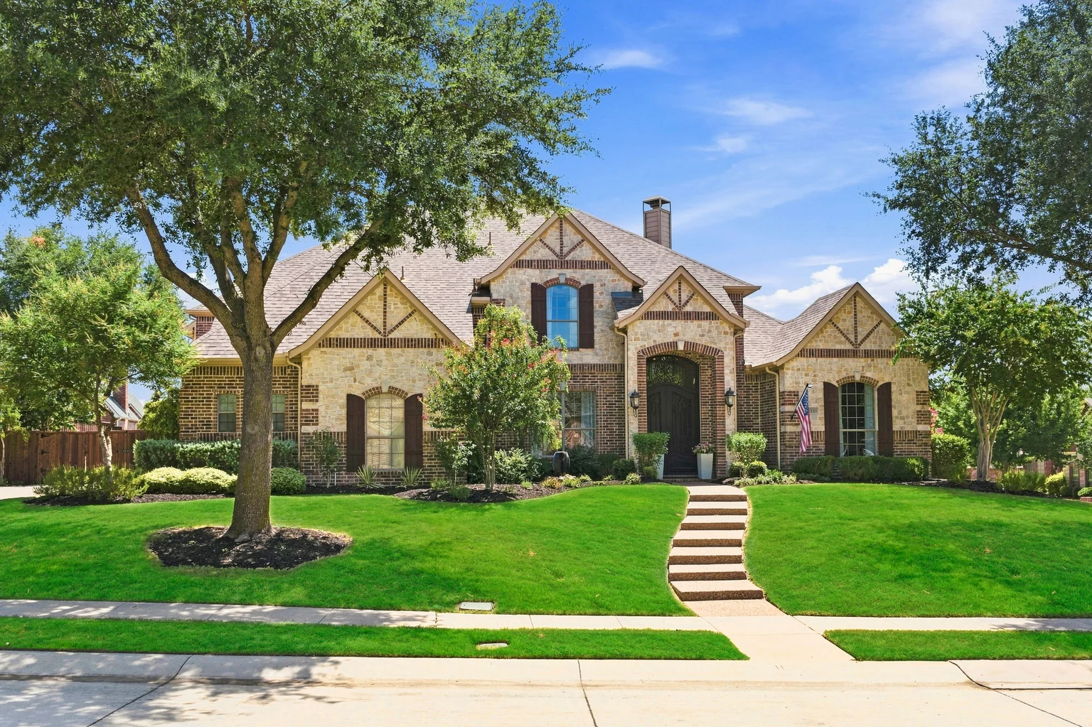Front exterior, landscaping and mature trees at 1000 Monticello Drive in Prosper