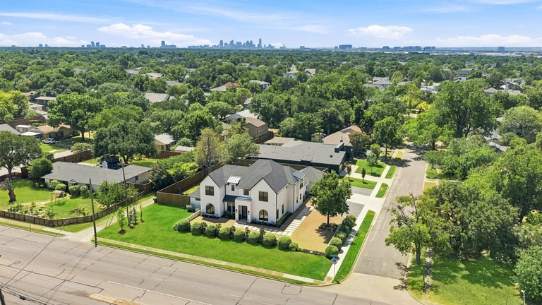 Aerial view of the house and surrounding trees at 3860 Walnut Hill Lane in Dallas