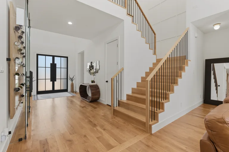 Entry hall and wood staircase at 3860 Walnut Hill Lane in Dallas