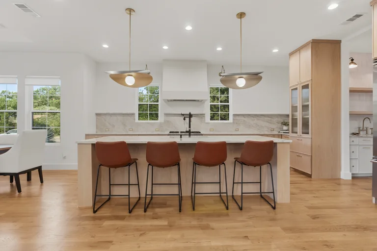 Kitchen island, cabinetry and bar seating at 3860 Walnut Hill Lane in Dallas