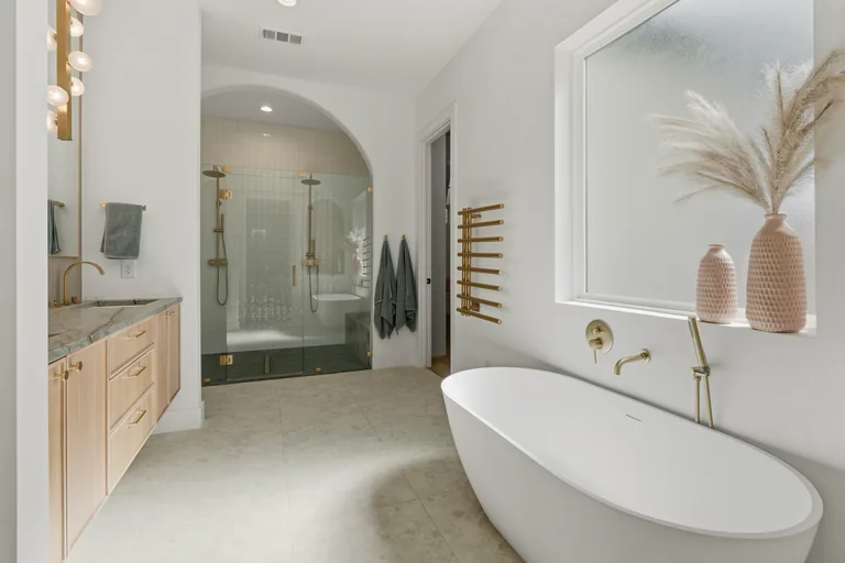 Freestanding tub, shower and wood vanity at 3860 Walnut Hill Lane in Dallas
