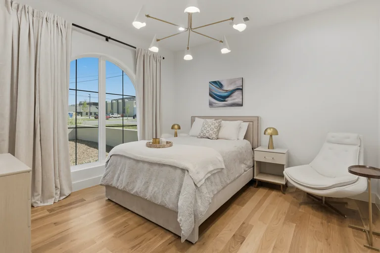 Guest bedroom with backyard windows at 3860 Walnut Hill Lane in Dallas