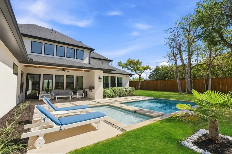 Pool, raised spa and rear exterior at 3860 Walnut Hill Lane in Dallas