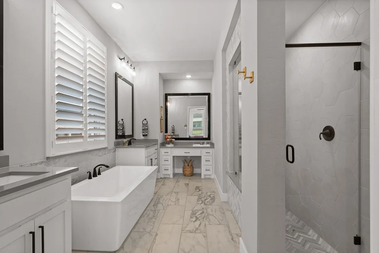 Bathroom with a long vanity, wall mirrors and walk-in shower — FLM media library example