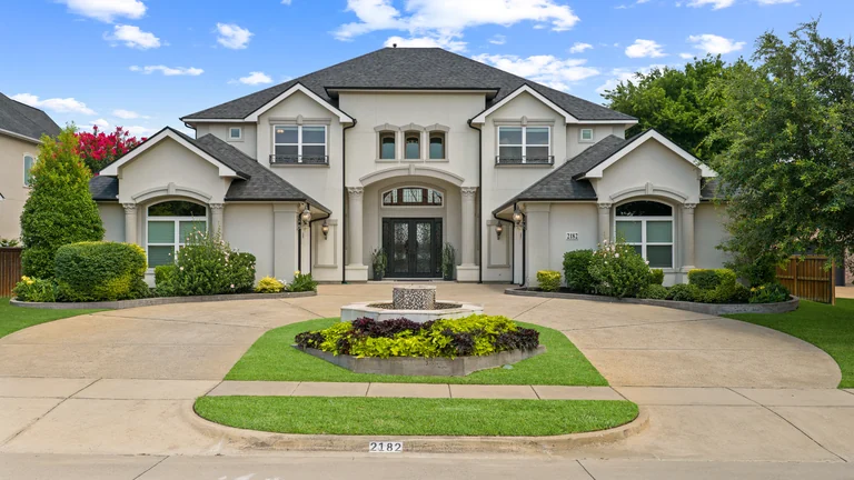 Front exterior and circular driveway of a large residential home — FLM media library example
