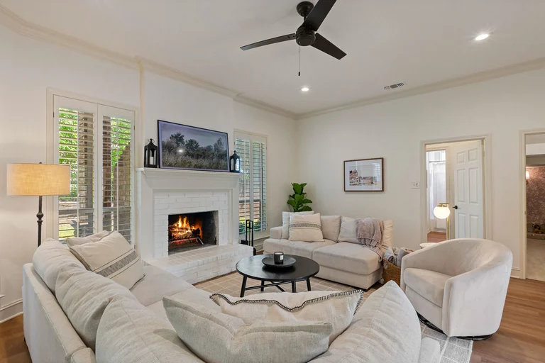 Neutral living room with fireplace and large windows — FLM media library example