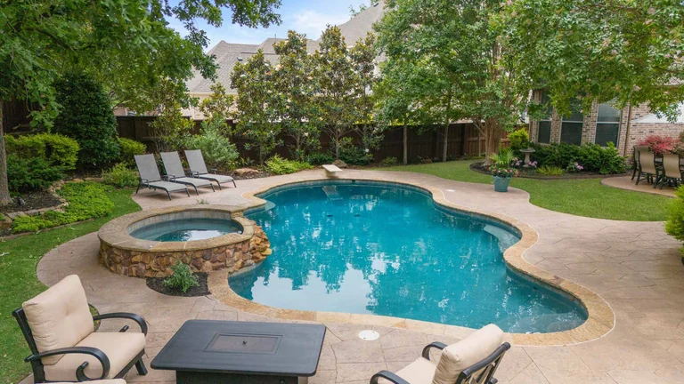 Backyard pool and raised spa beside a home — FLM media library example