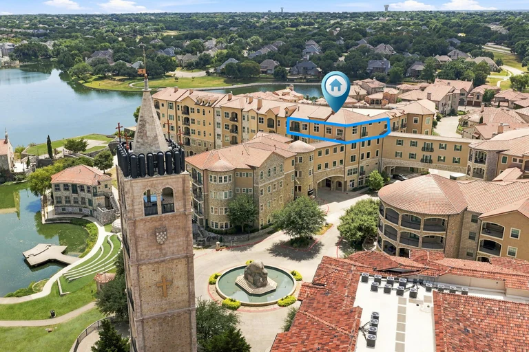 Aerial view of lakefront village buildings and a bell tower — FLM media library example